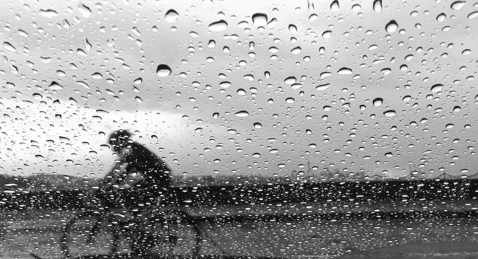 Man cycling in the pouring rain