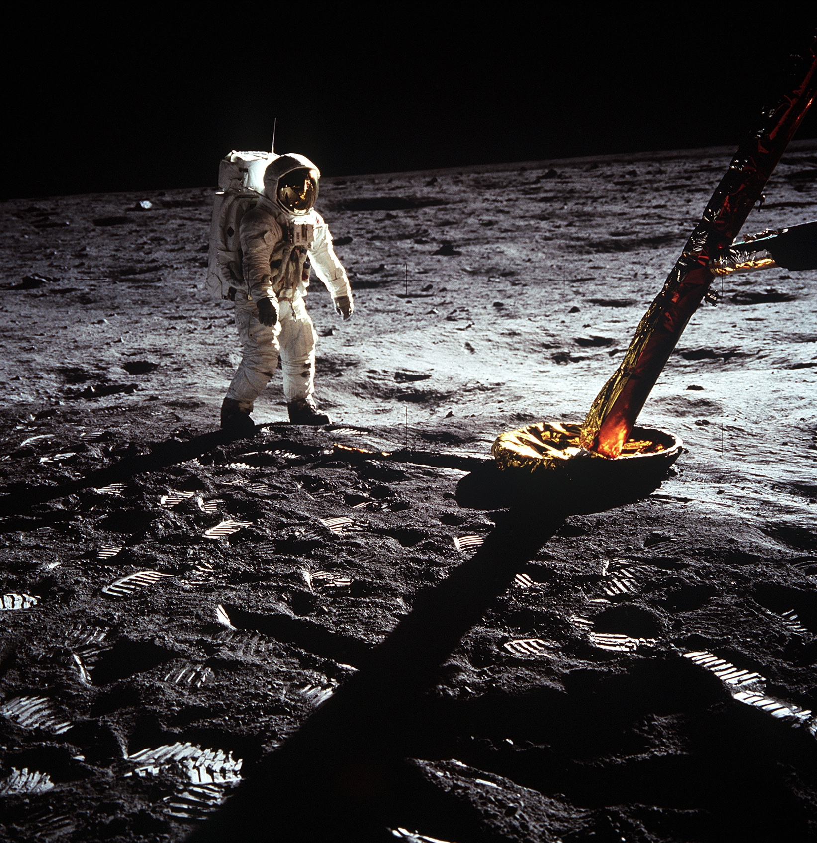 Astronaut Edwin Aldrin walks on lunar surface near leg of Lunar Module