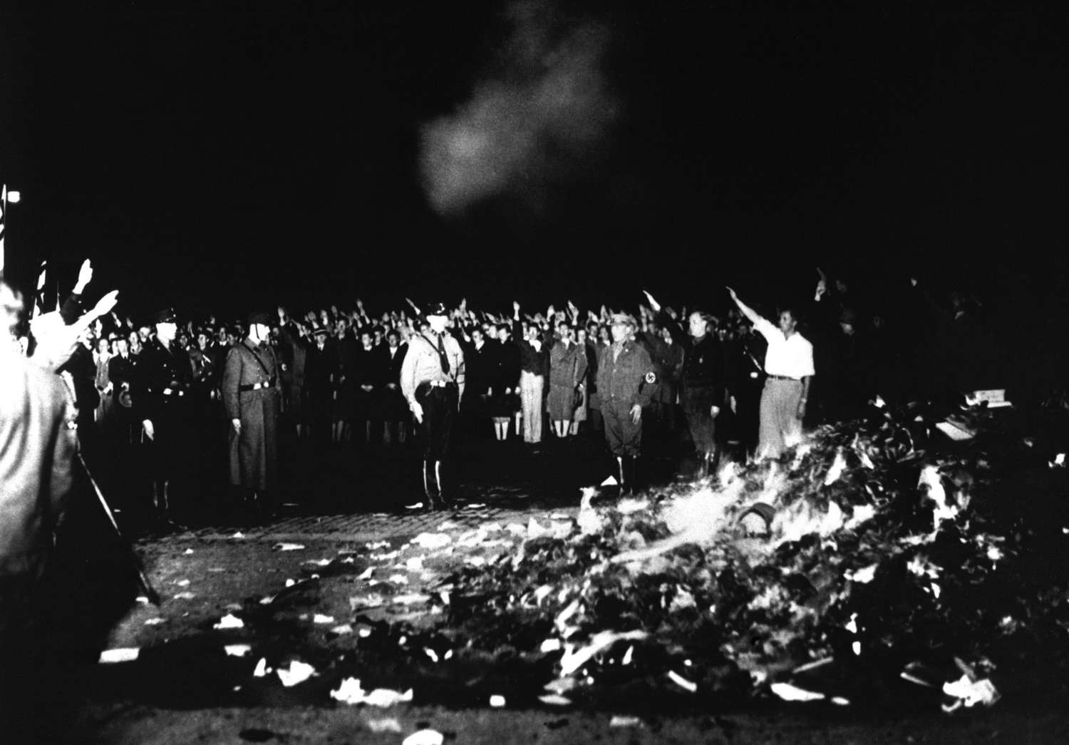 Thousands of books smolder in a huge Nazi huge bonfire, 1933. The book burnings were conducted by the German Student Association of Nazi Germany to burn books in Germany and Austria by classical liberal, anarchist, socialist, pacifist, communist, and Jewi