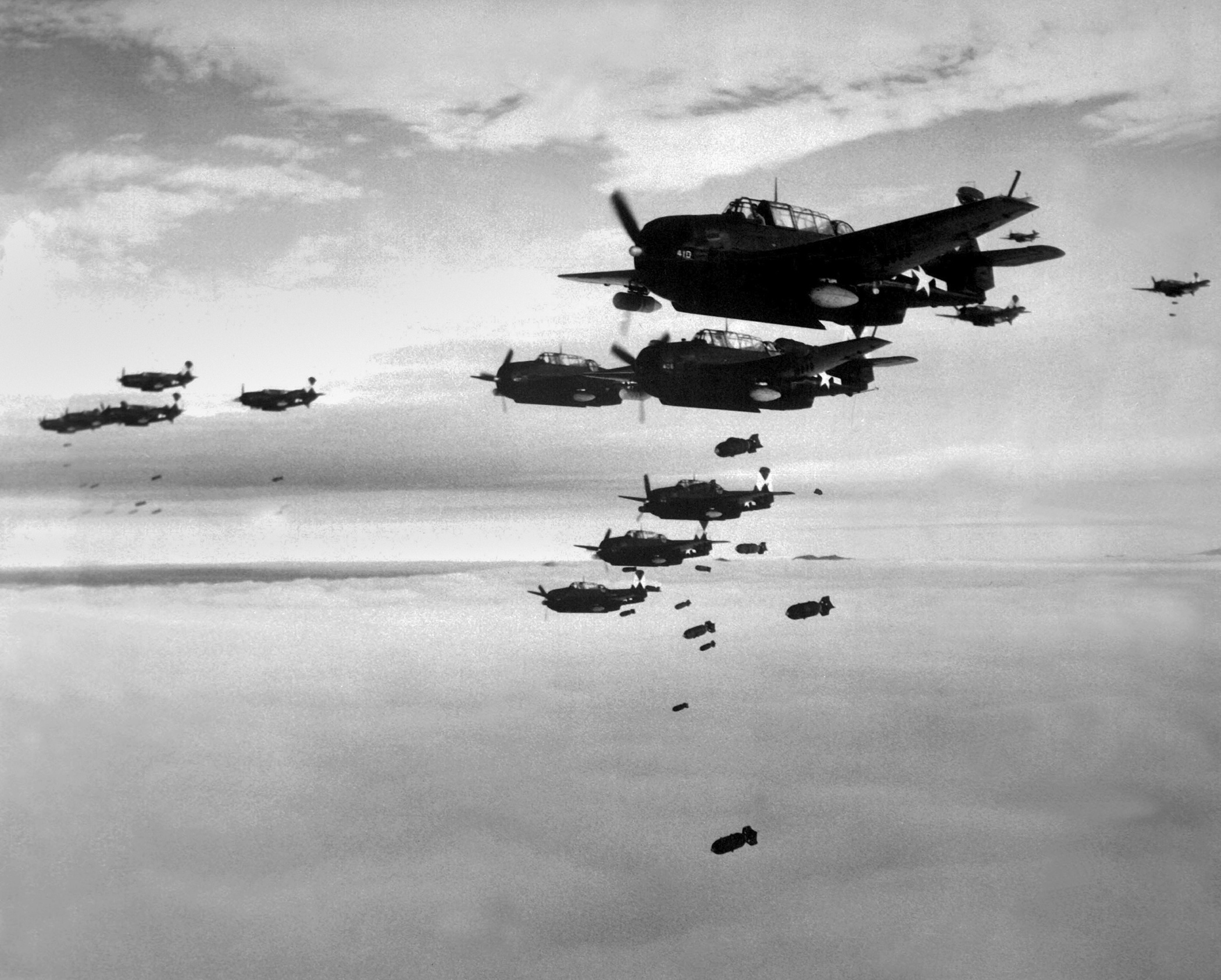 Planes from the USS Essex aircraft carrier dropping bombs on Hokadate, Japan, July 1945. World War 2, Pacific Ocean. (BSLOC_2013_13_7)